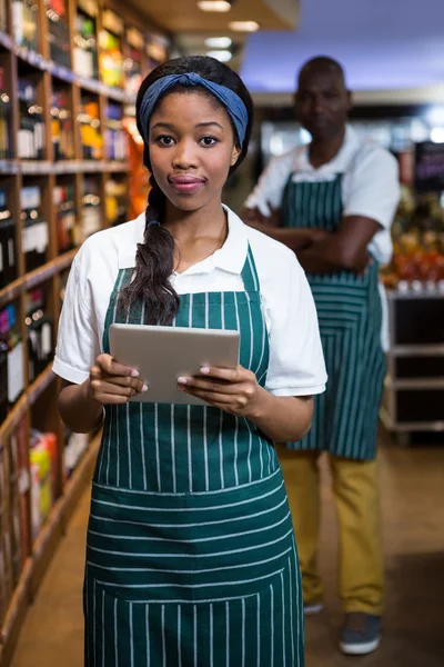 Female staff using digital tablet in organic section
