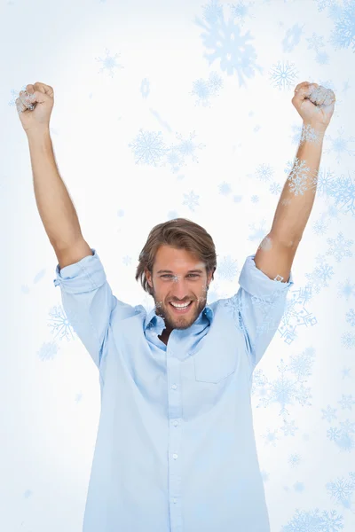 Happy man celebrating success with arms up