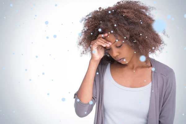 Sad woman holding her forehead with her hand