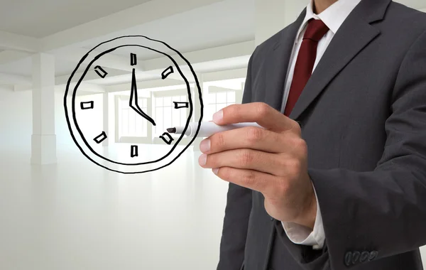 Business person drawing black clock
