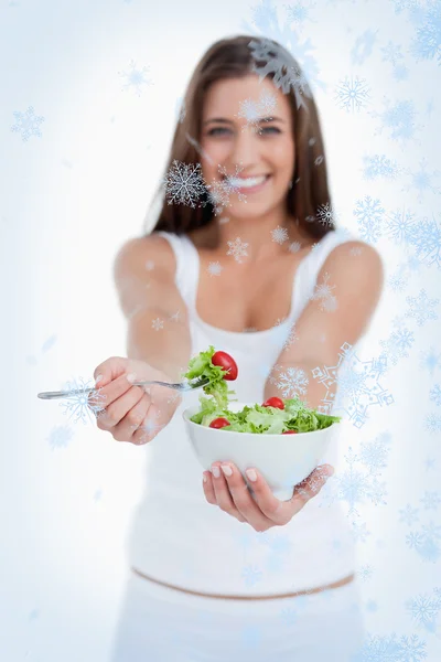 Delicious salad being eaten by woman