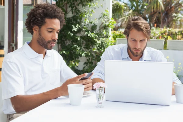 Two busy friends having coffee together