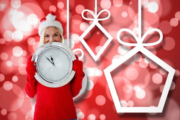 Composite image of happy festive blonde with clock