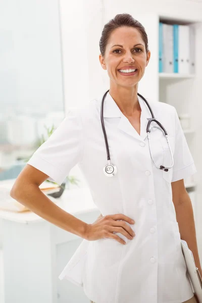 Confident female doctor with stethoscope at medical office