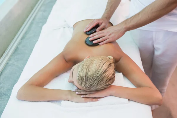 Woman receiving stone massage at health farm