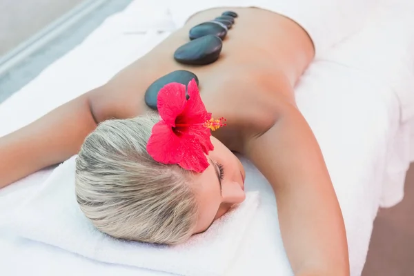 Woman receiving stone massage at health farm