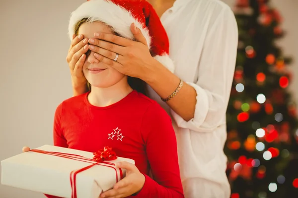 Mother surprising her daughter with christmas gift