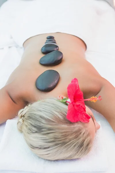 Woman receiving stone massage at health farm