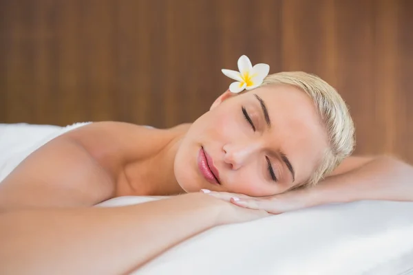 Beautiful woman lying on massage table