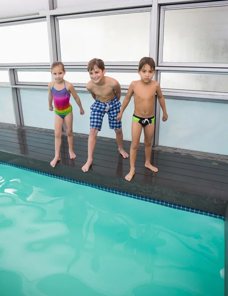 Cute swimming class about to jump in pool