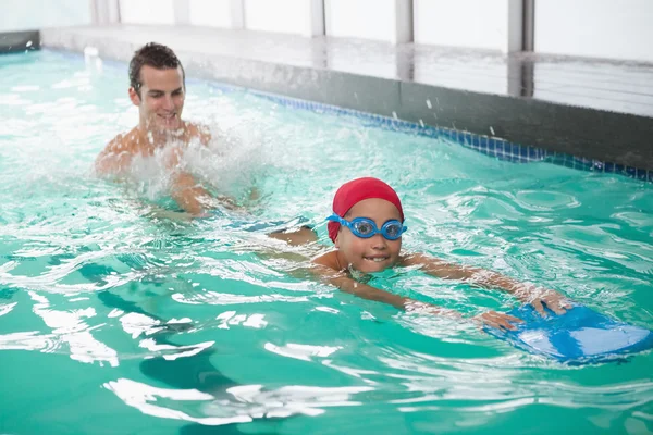 Boy learning to swim with coach