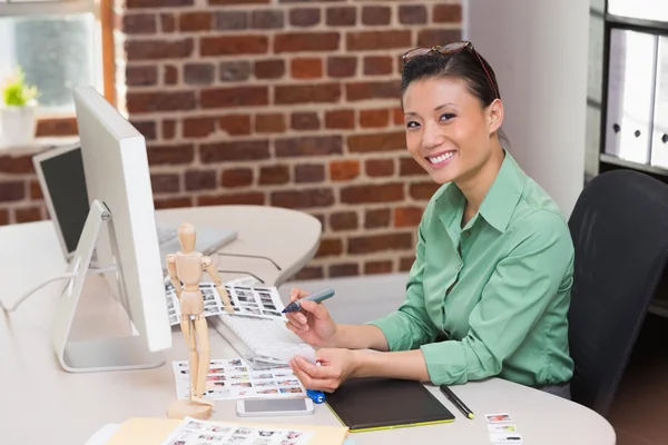 Female photo editor using computer