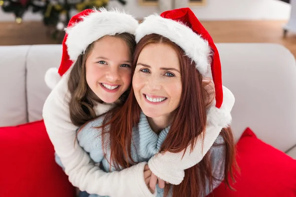 Festive mother and daughter on the couch