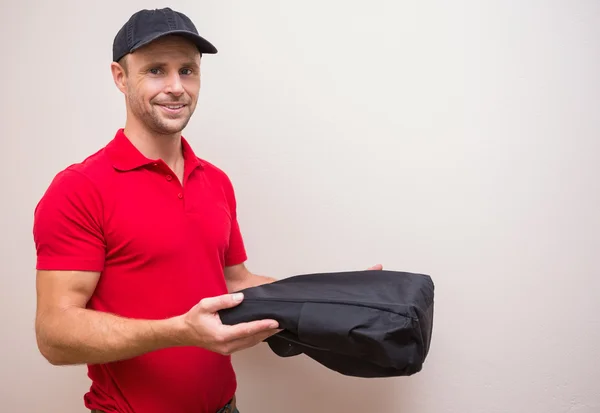 Delivery man holding pizza in thermal bag
