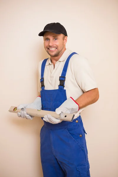 Construction worker holding spirit level