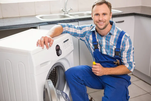 Handyman fixing a washing machine