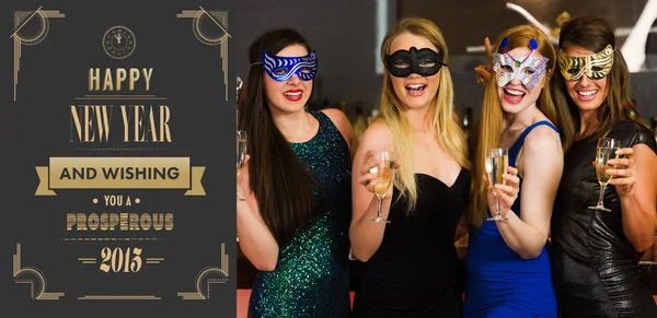 Friends wearing masks holding champagne