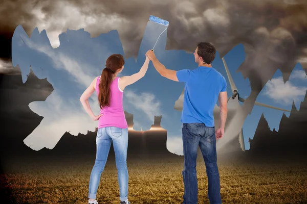 Couple painting a wall together