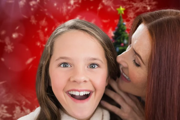 Composite image of mother and daughter telling secrets
