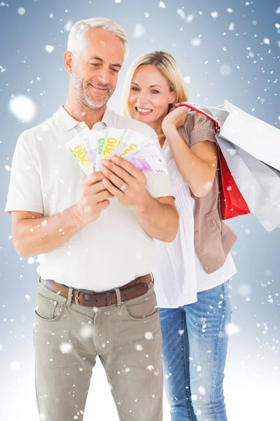 Couple with shopping bags and cash