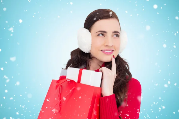 Brunette with ear muffs holding shopping bag