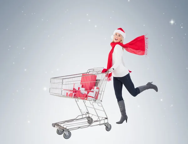 Blonde pushing trolley full of gifts