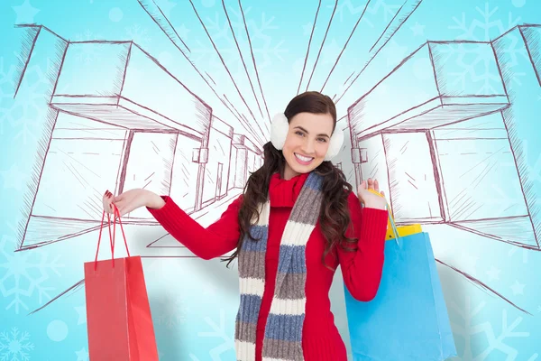 Brunette in winter clothes holding shopping bags