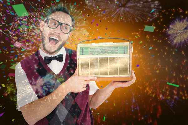 Geeky hipster holding retro radio