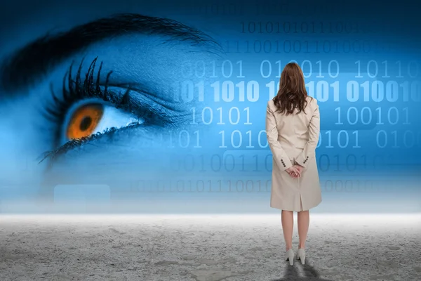 Businesswoman against eye with binary code