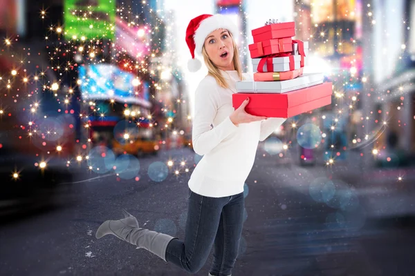 Festive blonde holding pile of gifts