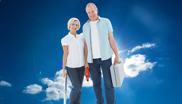 Happy older couple holding diy tools