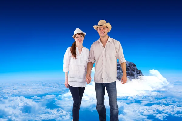 Smiling couple both wearing hats