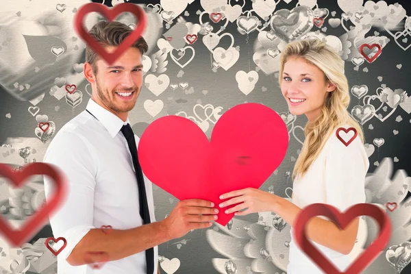 Attractive couple holding red heart