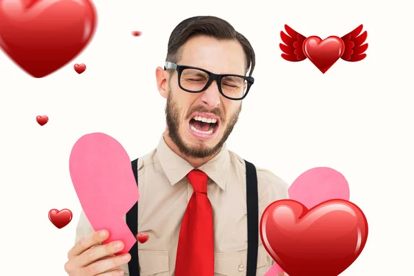 Geeky hipster holding broken heart card