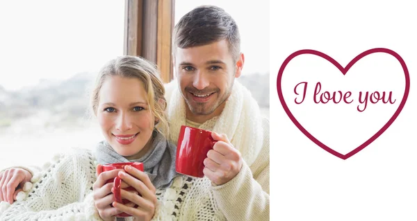 Couple in winter clothing with coffee cups