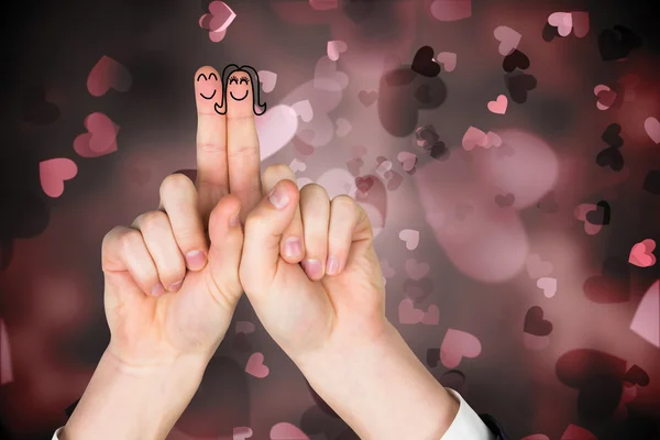 Composite image of fingers crossed like a couple