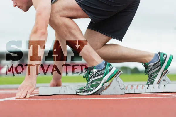 Side view of a man ready to race on running