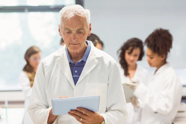 Science lecturer holding tablet pc in lab