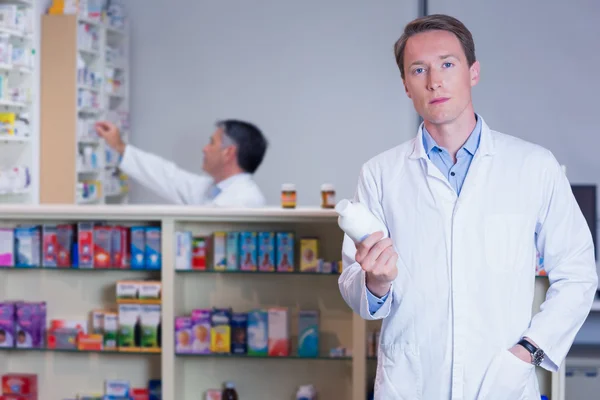 Concentrating doctor holding medicine jar