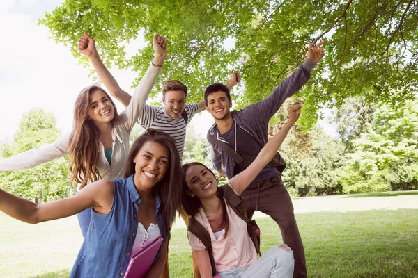 Happy students posing and smiling outside