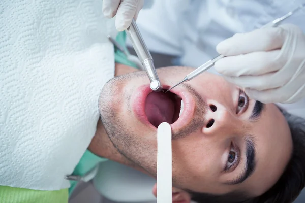 Close up of man having his teeth examined