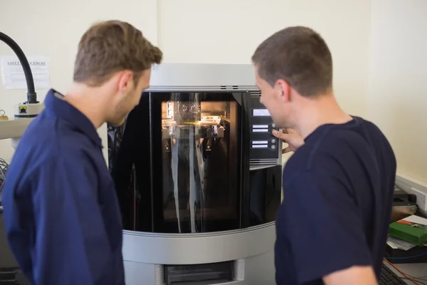 Engineering students using 3d printer