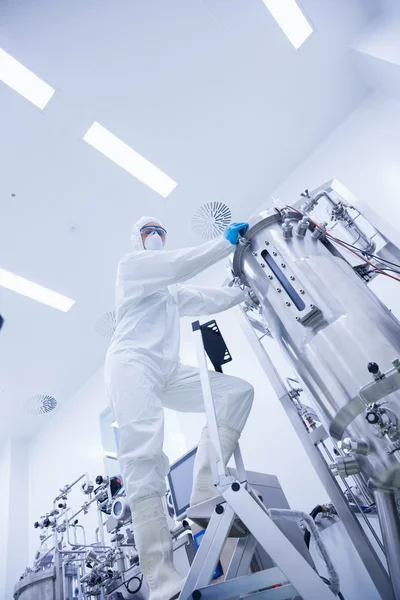 Scientist standing on ladder looking at the camera