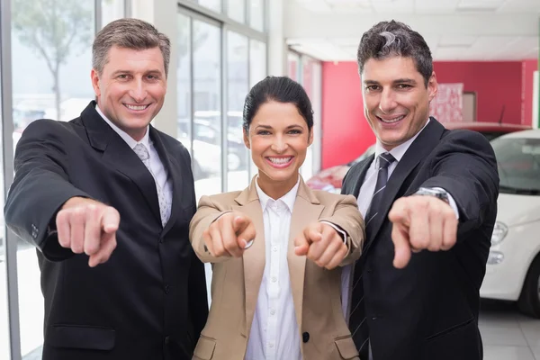 Business team pointing at camera