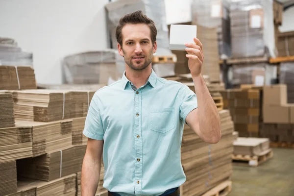 Warehouse worker showing small box