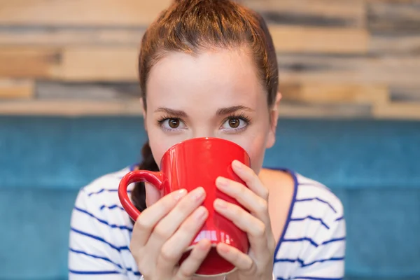 Woman having mug of coffee