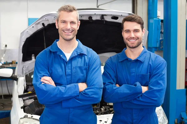 Team of mechanics smiling at camera