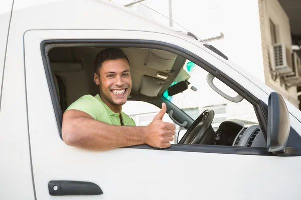 Man showing thumbs up driving his van