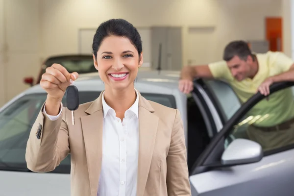 Saleswoman showing customer car key