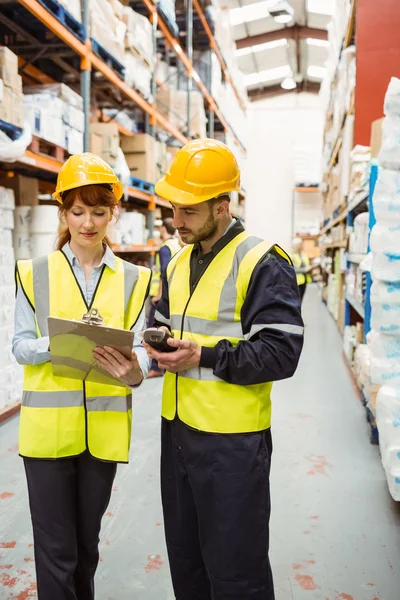 Warehouse manager talking with worker